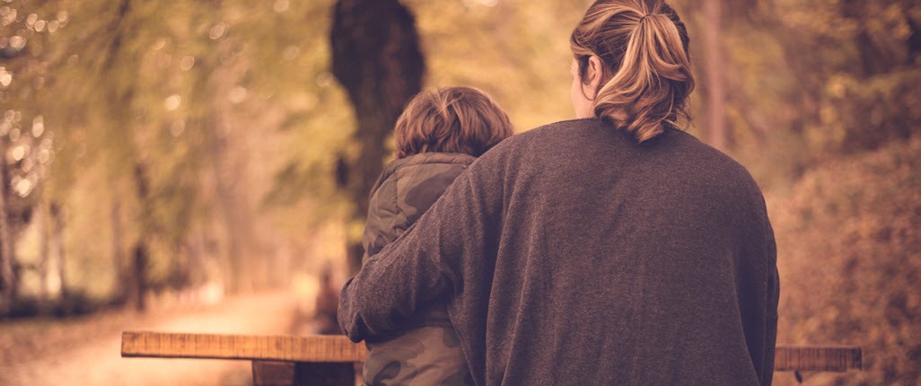 Mother hugs her son