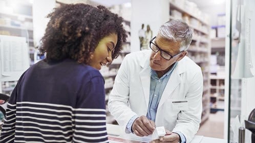 Pharmacist giving medicine